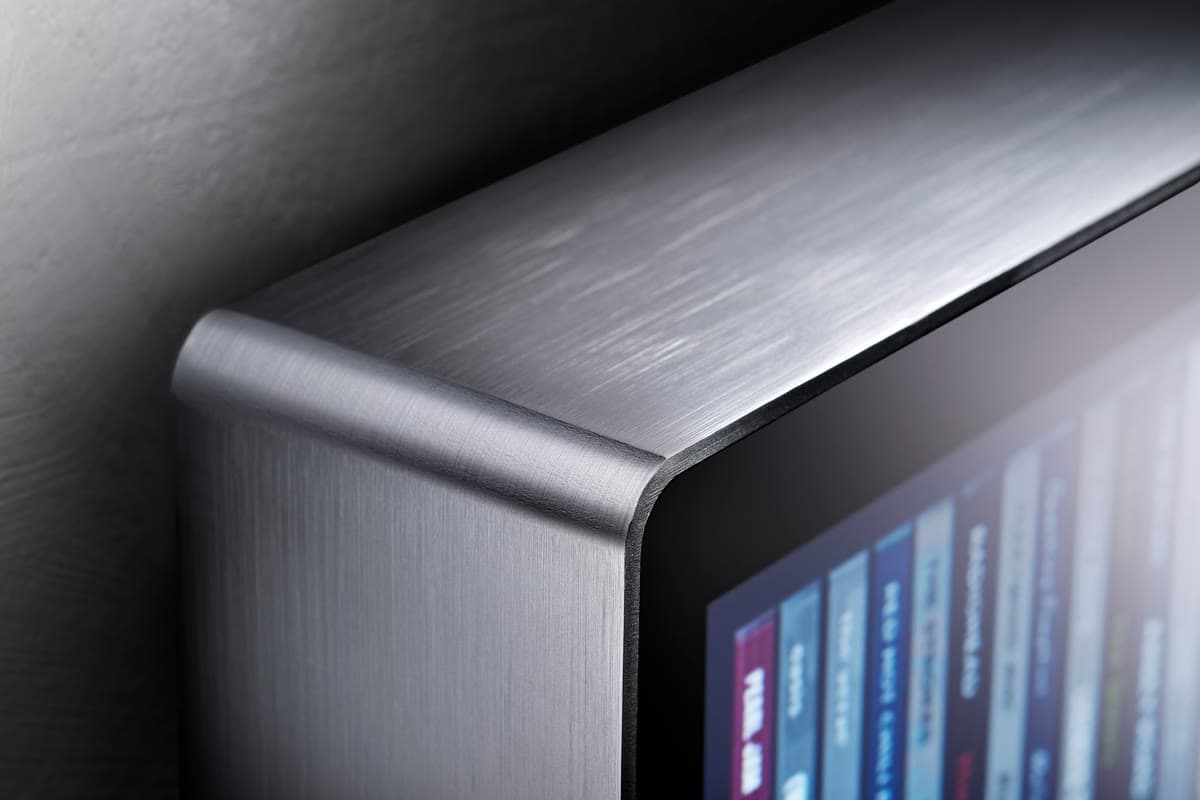 Close-up of the rounded corner of Spine's brushed aluminium body, formed from a single sheet.