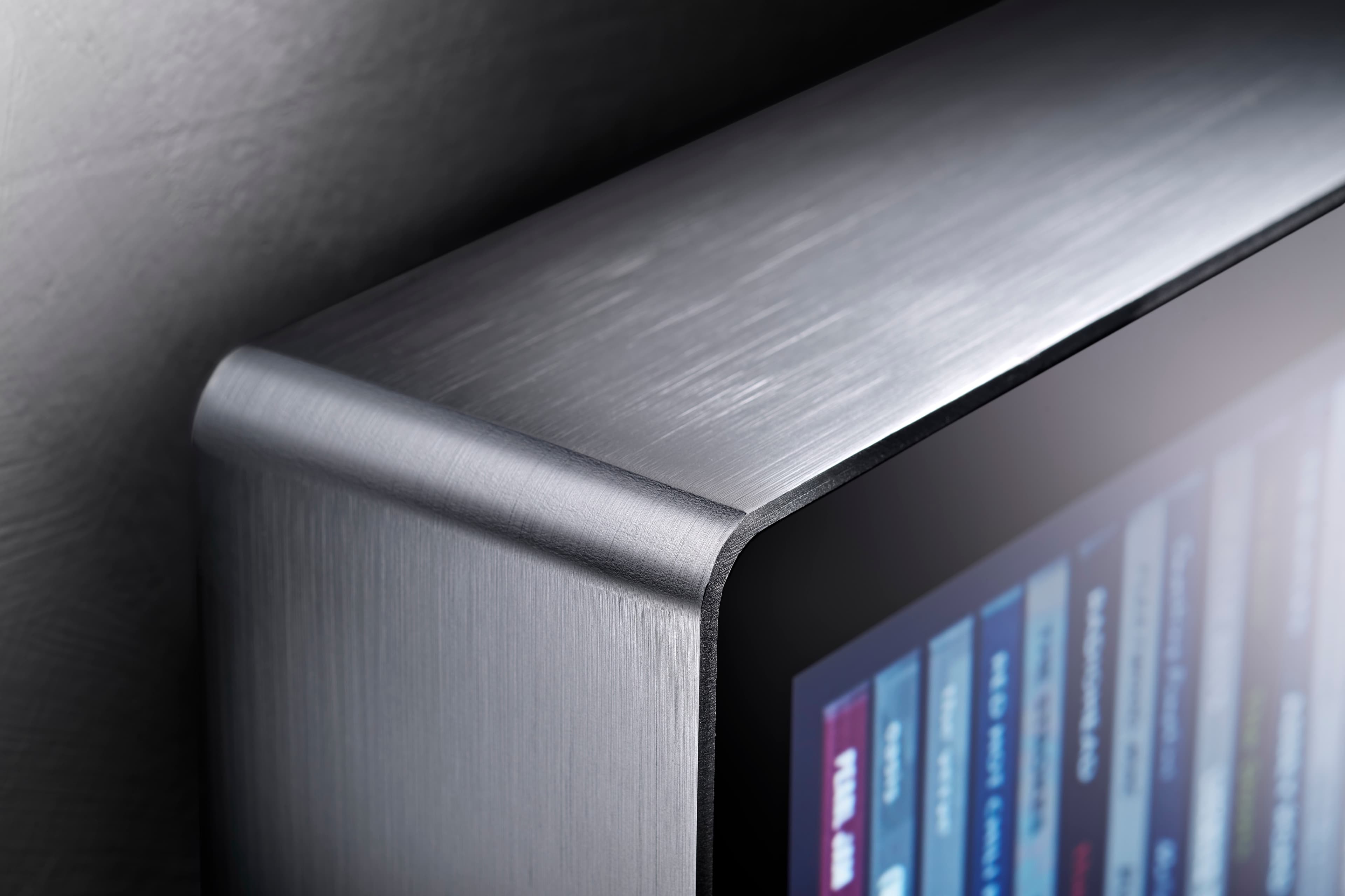 Close-up of the rounded corner of Spine's brushed aluminium body, formed from a single sheet