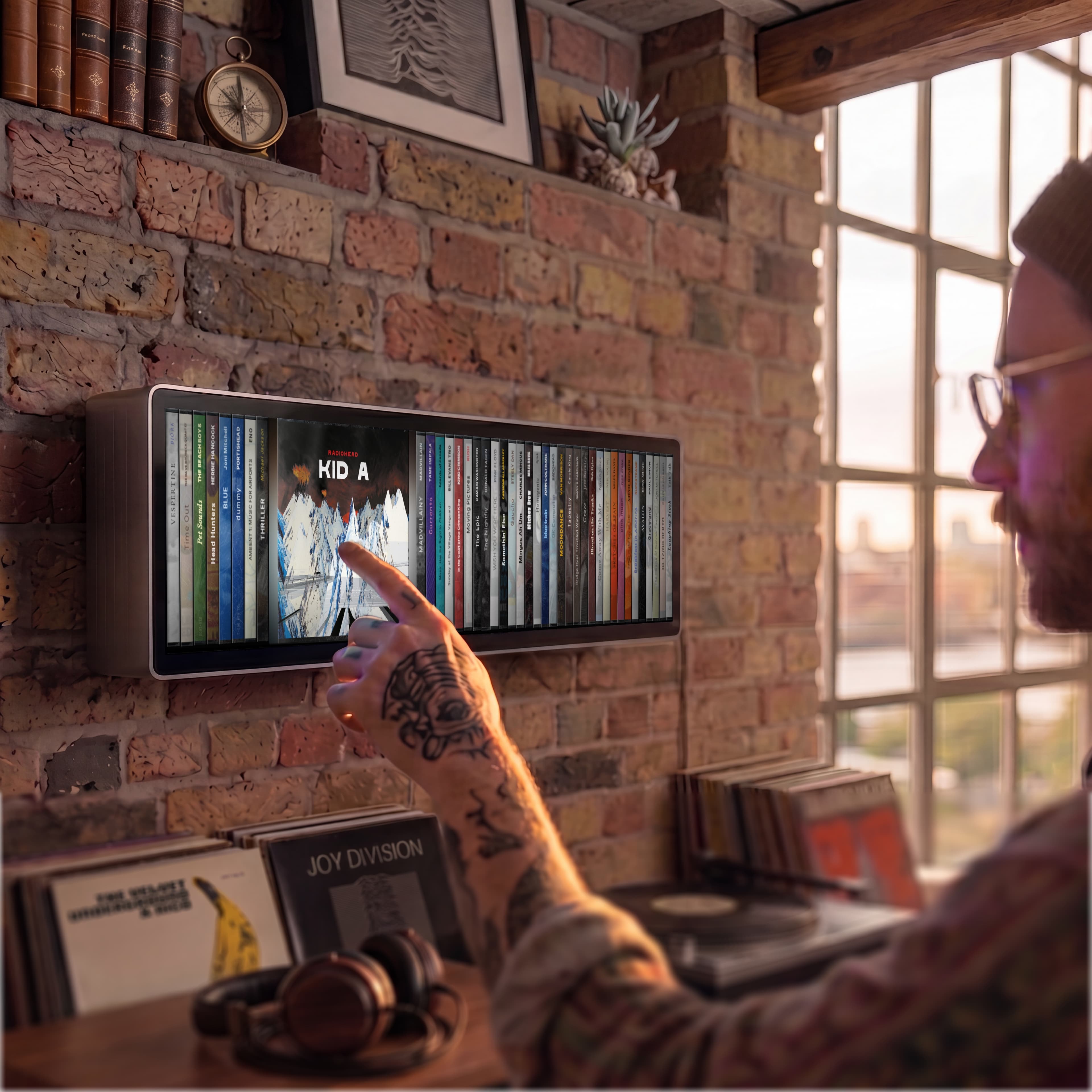 Render of a man browsing albums on Spine, mounted on a brick wall above a record player